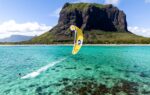Cabrinha Nitro Apex kite flying over turquoise water below Le Morne