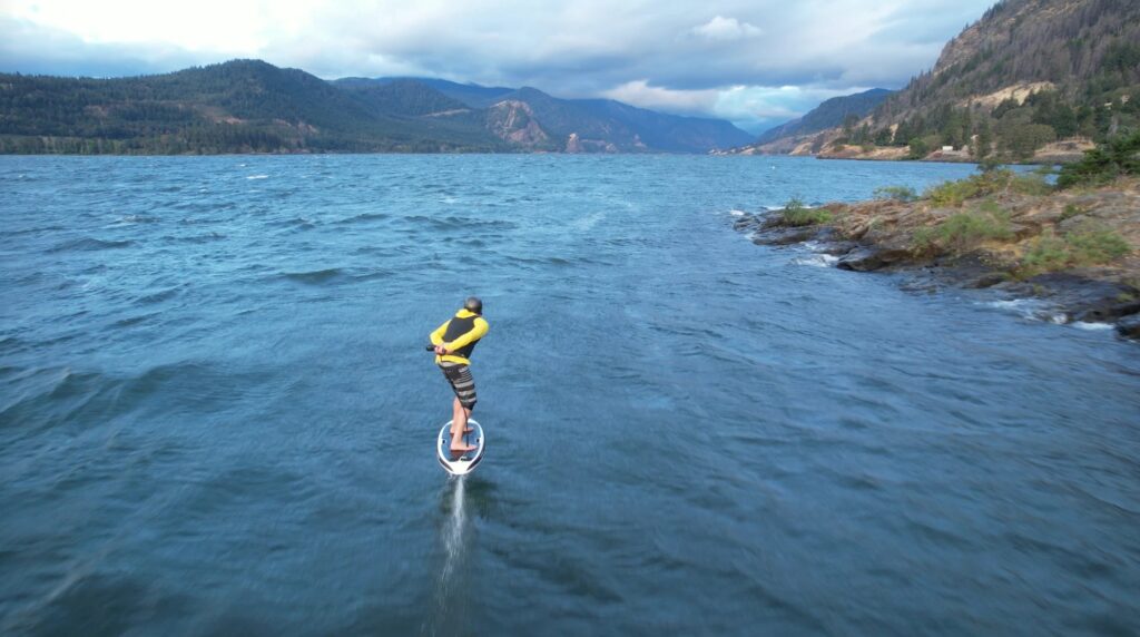 T.J. Gulizia riding a LiftX eFoil wearing a helmet and life vest at the Hatchery, Columbia River Gorge. Drone: Dan Gavere