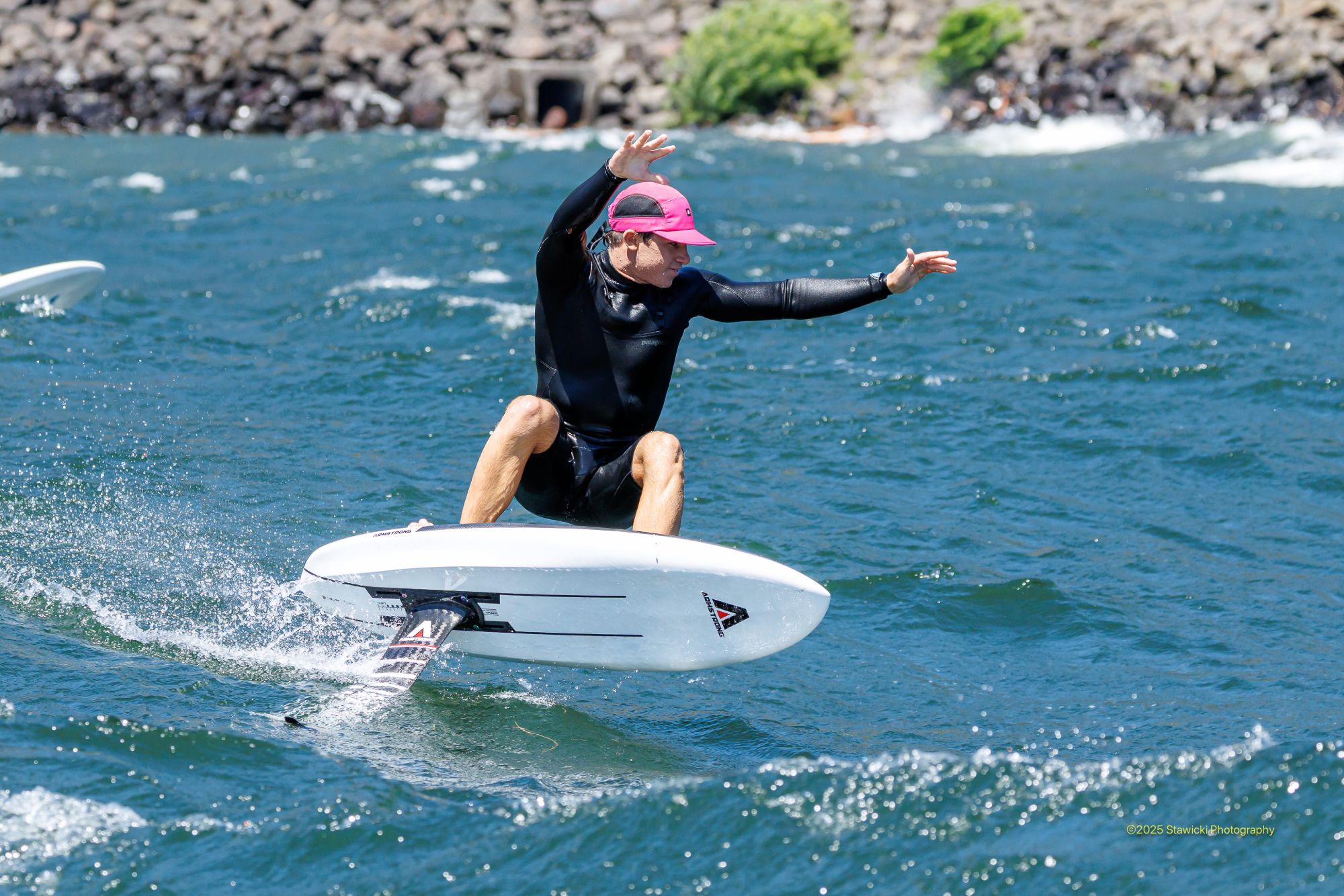 Foil surfer wearing the Armstrong 5 Panel Water Cap in Signal Pink on the Columbia River Gorge