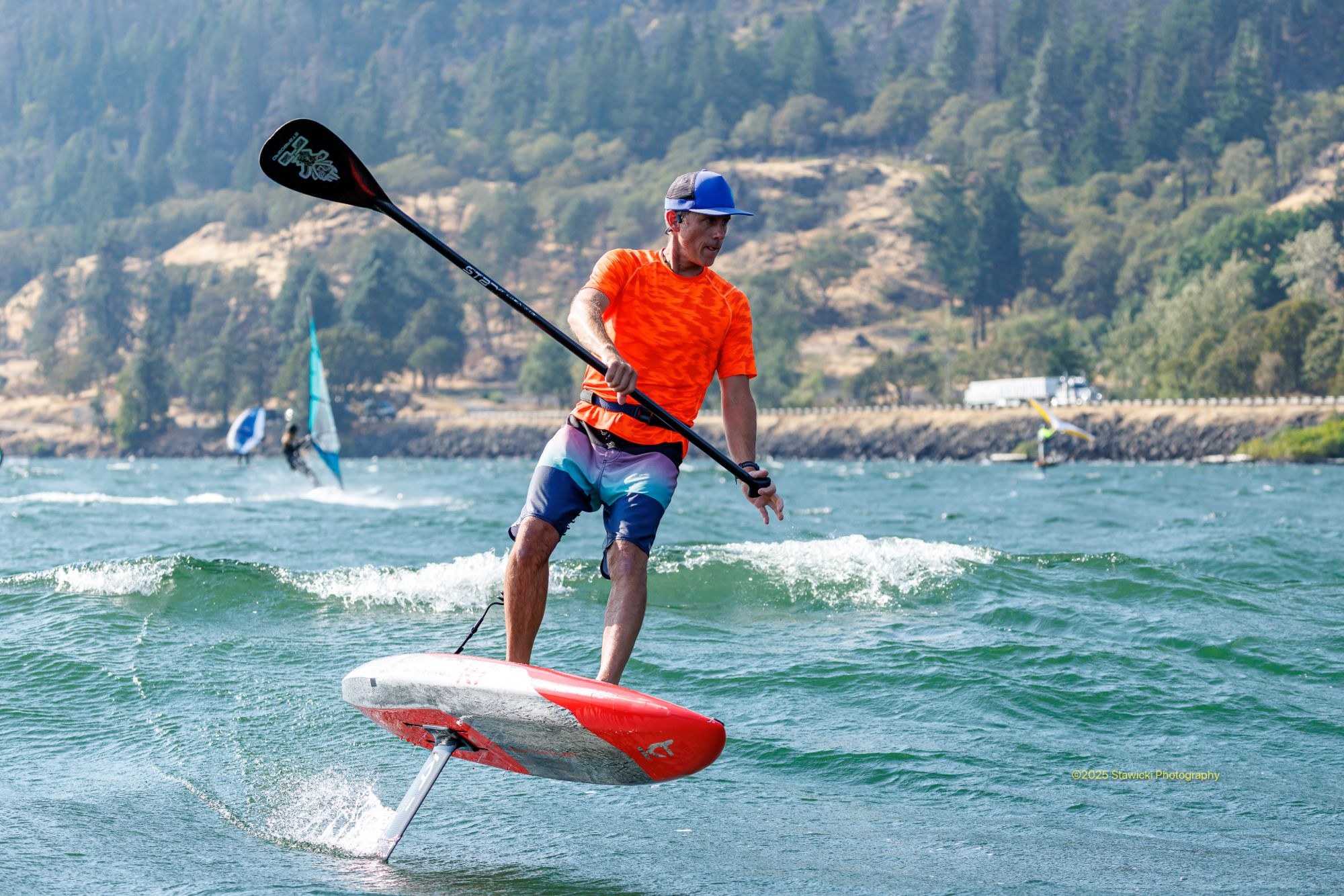 orange-top-sup-foil-gorge-stawicki-2025 SUP foiler in a bright orange top on the Columbia River Gorge. Photo: Bob Stawicki