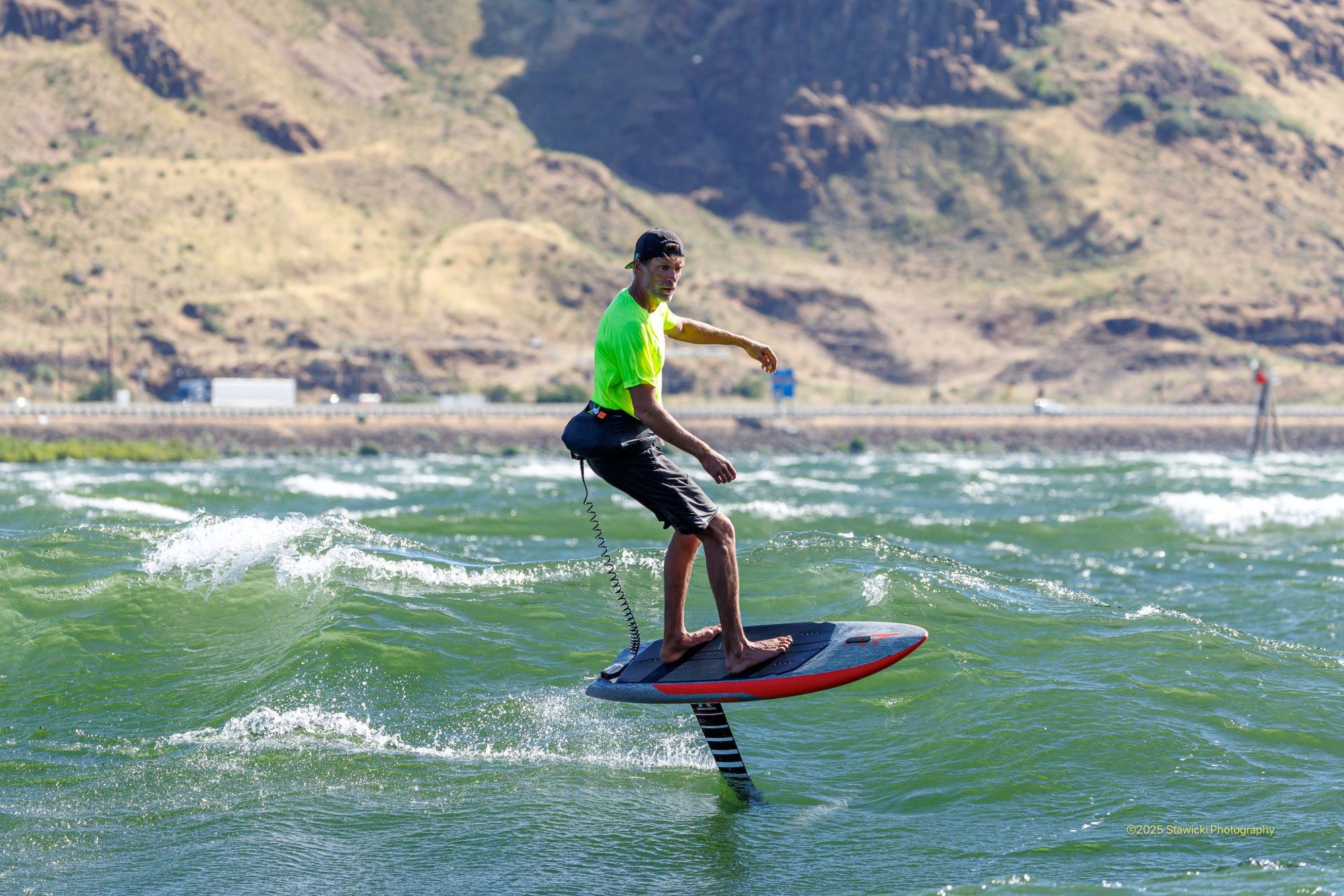 neon-yellow-top-downwind-foil-stawicki-2025 Downwind foiler in a neon yellow top on the Columbia River Gorge. Photo: Bob Stawicki