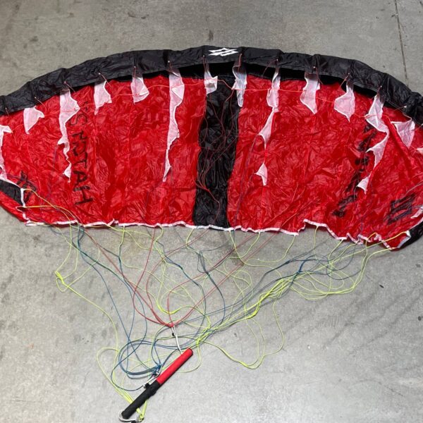 Used Naish Hatch V1 parawing 2.7m Red laid out on the shop floor