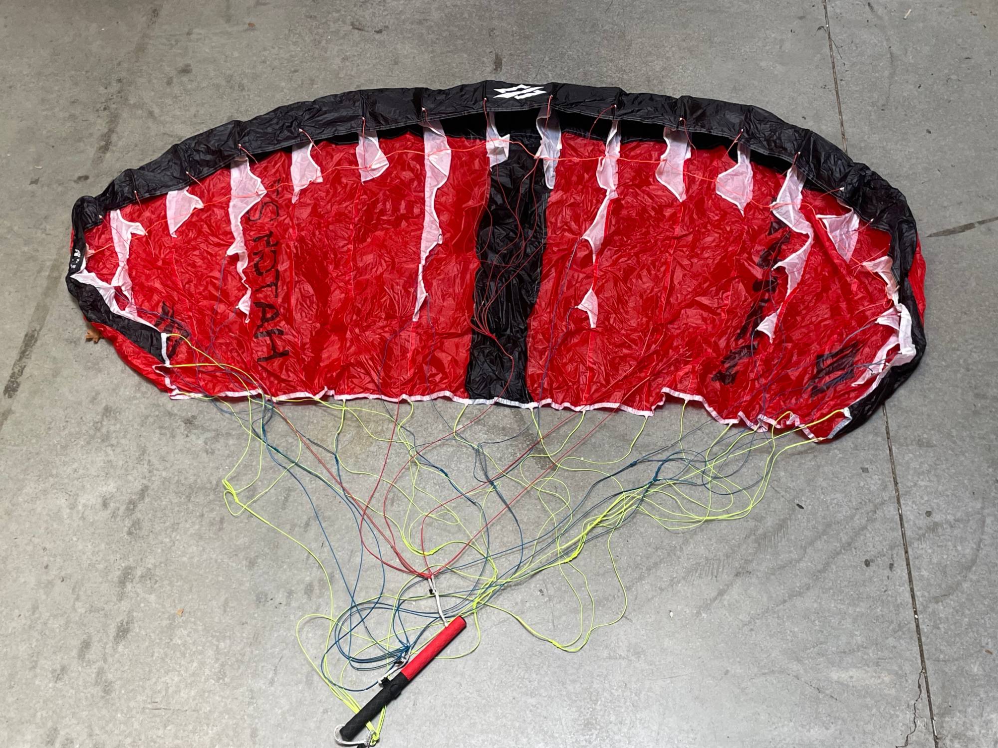used-2.7m-5.jpg Used Naish Hatch V1 parawing 2.7m Red laid out on the shop floor